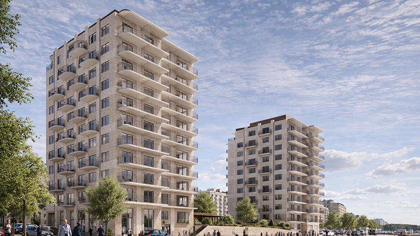 Två ljusa flerbostadshus med balkonger i stadsmiljö under blå himmel.