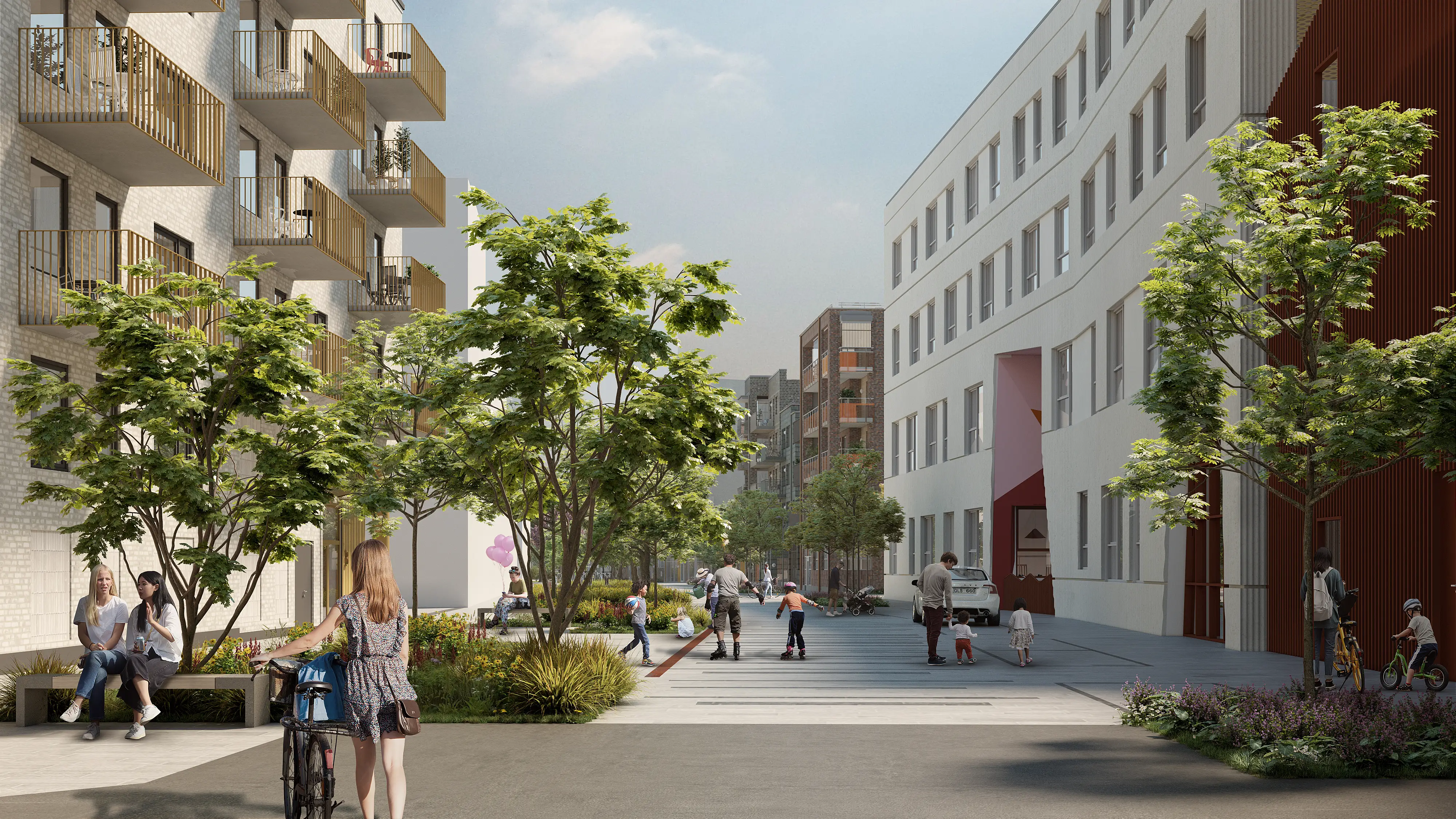 Stenlagd gata med grönska längs husväggarna. En kvinna leder sin cykel