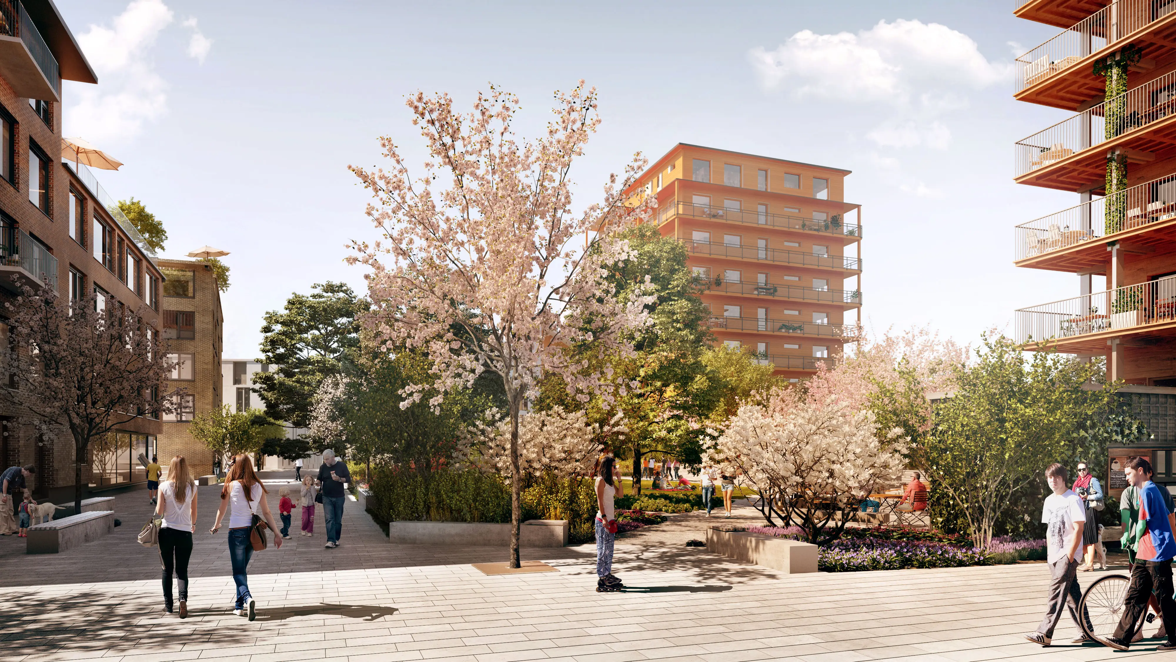 Stenlagd yta med en park. Människor rör sig på bilden. 